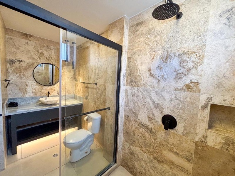 Baño de mármol con ducha tipo lluvia